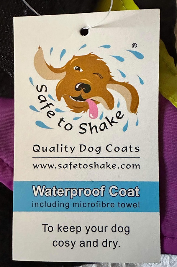 A dog coat label showing that it is waterproof and includes a microfibre towel